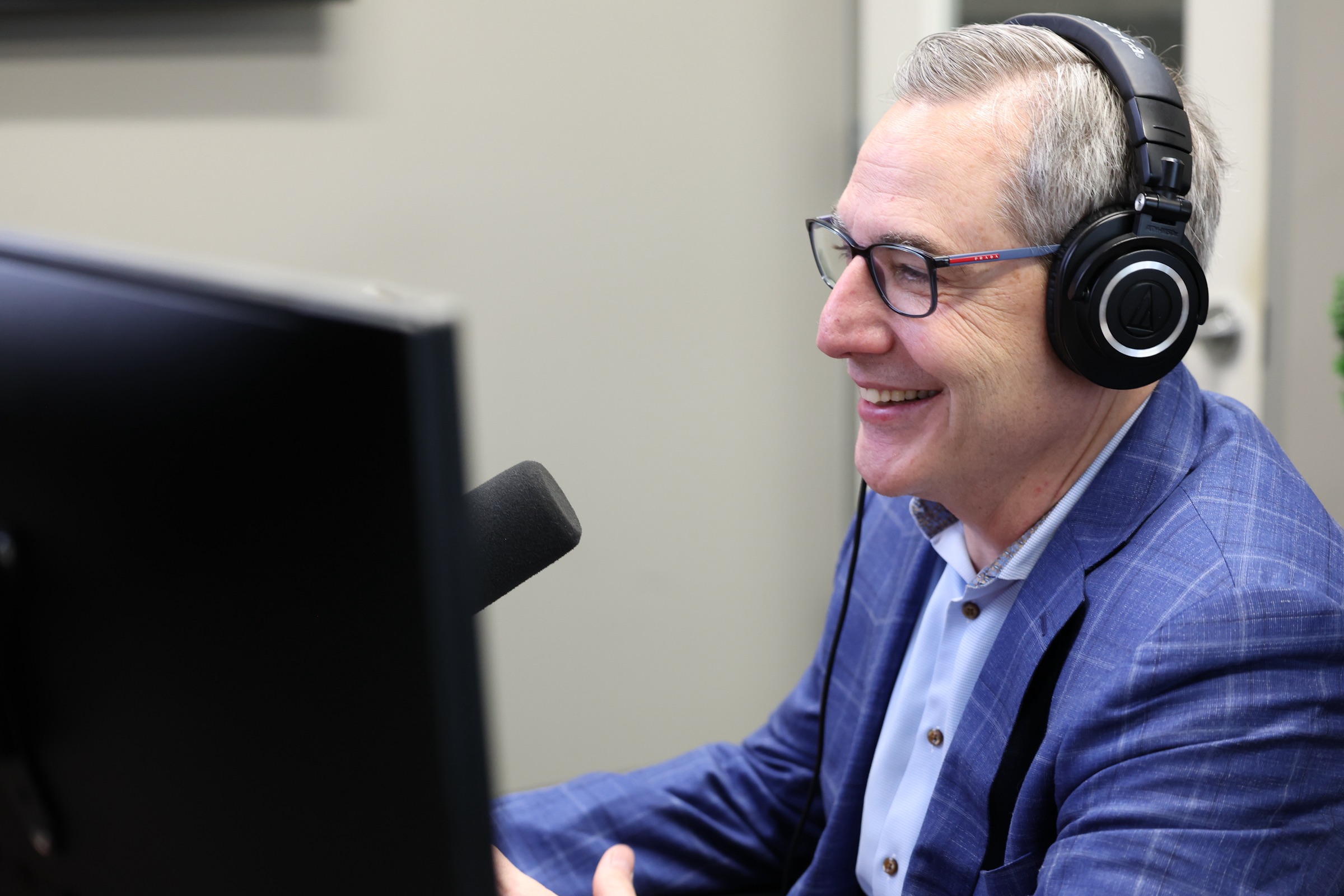 Ed McGill in profile wearing headphones in the LED studio